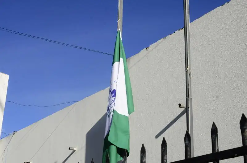 Bandeira à meia-haste representando luto.